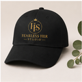 Black cap with 'Fearless Her Studio' logo on a light background