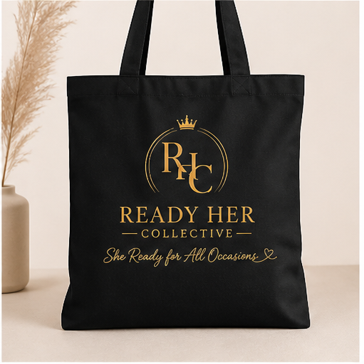 Black tote bag with gold logo and text on a light background